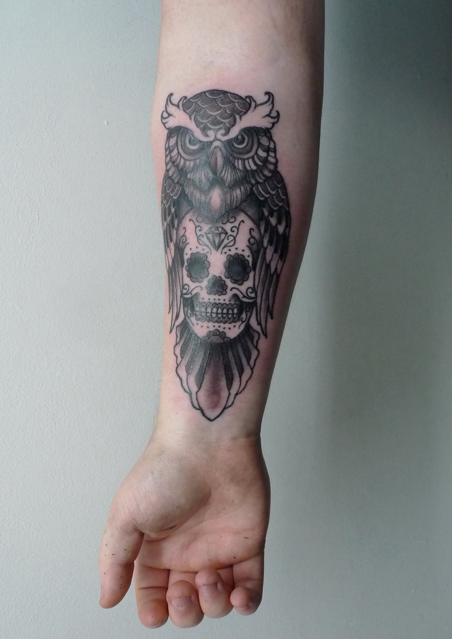 Owl skull tattoo on the back